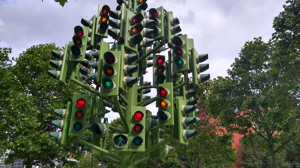 A piece of public art which is essentially a green steel tree with "fruit" that are actual working traffic signal heads.