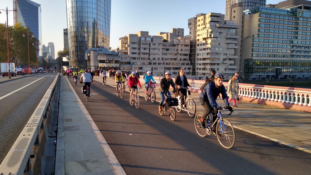 A two way cycle track with a footway to the right crossing Blackfriars Bridge. There are people walking and cycling.